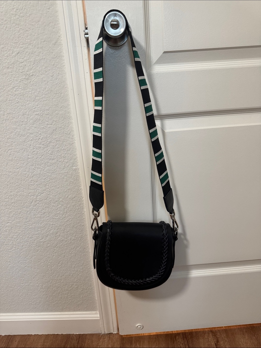 Black Saddle Crossbody Bag with Striped Green-White Strap